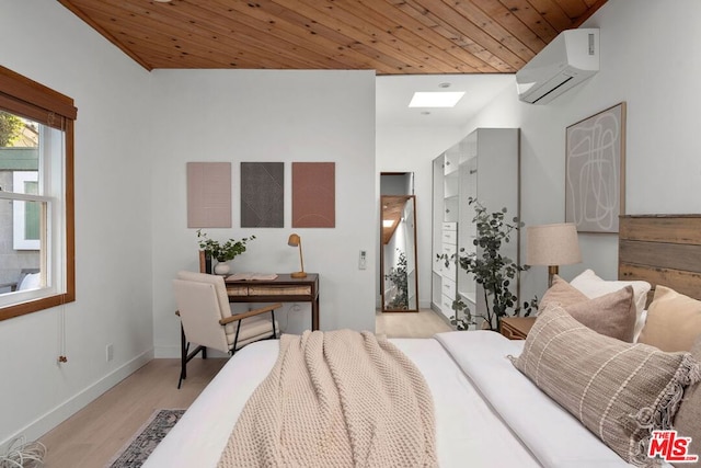 bedroom featuring a wall unit AC, wood ceiling, and light hardwood / wood-style floors