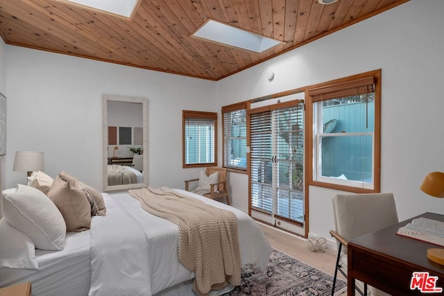 bedroom featuring ornamental molding, a skylight, wooden ceiling, and light hardwood / wood-style floors