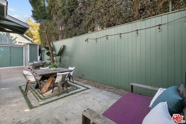 view of patio / terrace with a shed