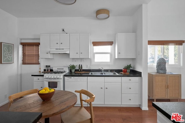 kitchen with sink, white cabinets, white appliances, and light hardwood / wood-style flooring