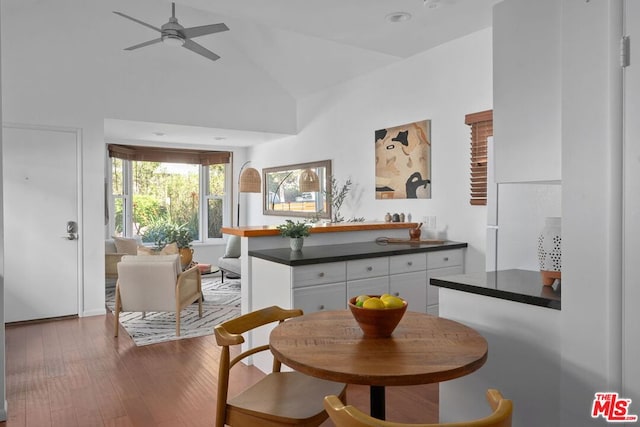 interior space with ceiling fan, dark hardwood / wood-style flooring, and high vaulted ceiling