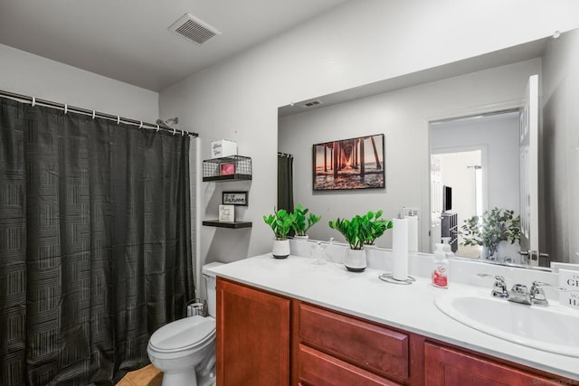 bathroom featuring vanity, curtained shower, tile patterned floors, and toilet