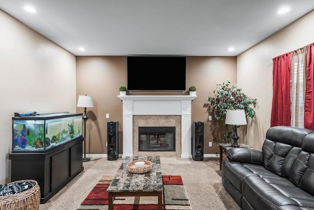 carpeted living room with a tile fireplace