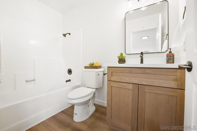 full bathroom featuring wood-type flooring, vanity, shower / bathtub combination, and toilet