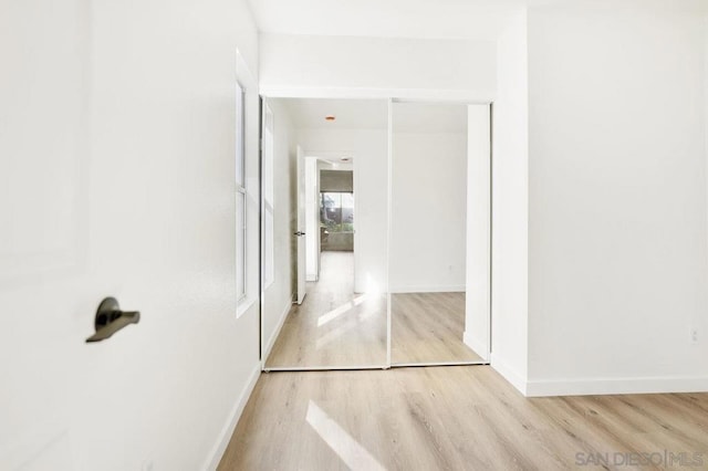 corridor with light wood-type flooring