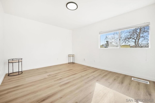 spare room with light hardwood / wood-style floors