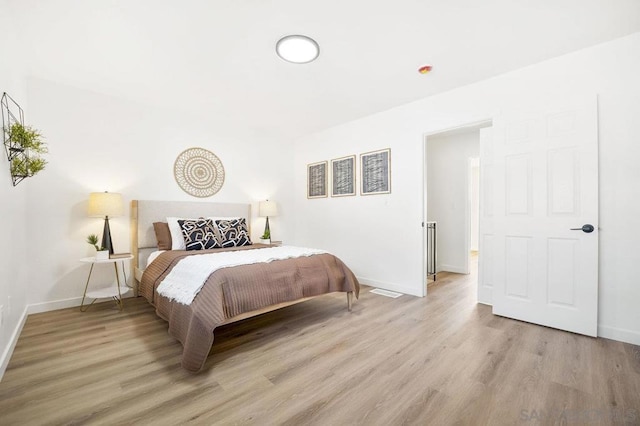 bedroom with light hardwood / wood-style floors