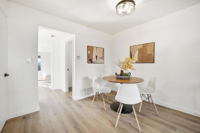 dining room with light wood-type flooring