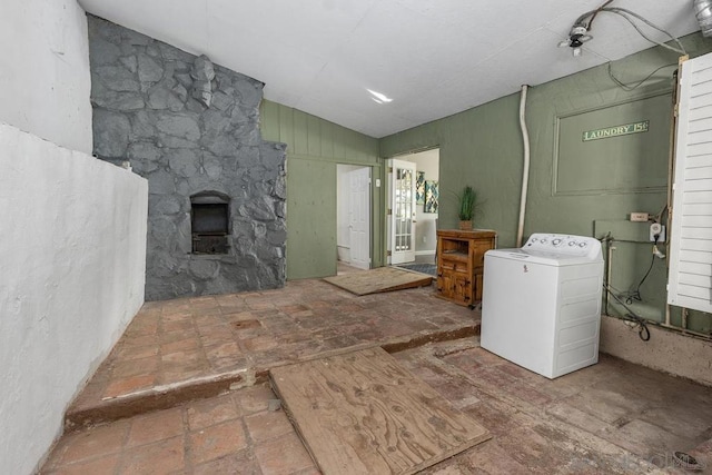 bathroom with washer / dryer and a stone fireplace