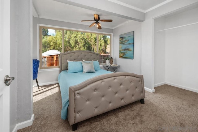 carpeted bedroom with ornamental molding and ceiling fan