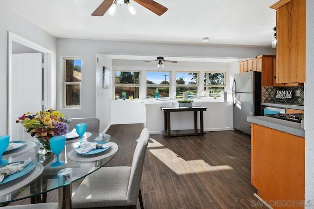 kitchen with appliances with stainless steel finishes, dark hardwood / wood-style flooring, and decorative backsplash