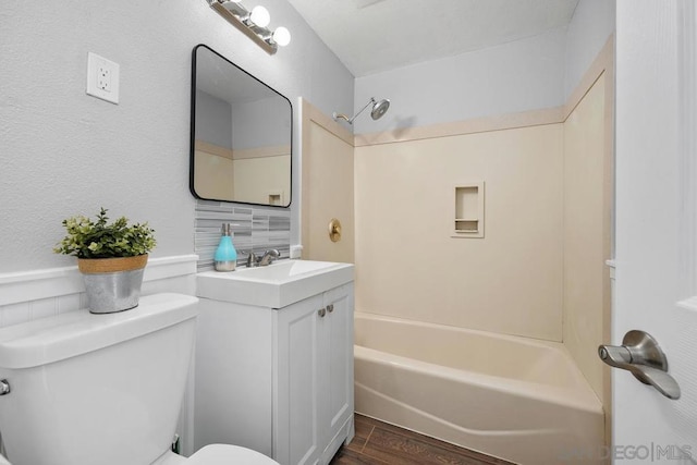 full bathroom featuring toilet, tub / shower combination, vanity, hardwood / wood-style floors, and backsplash