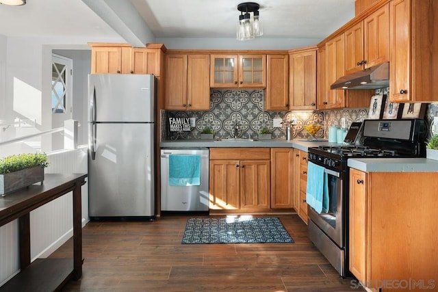 kitchen with stainless steel appliances, sink, dark wood-type flooring, and backsplash