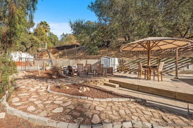 view of patio featuring a shed