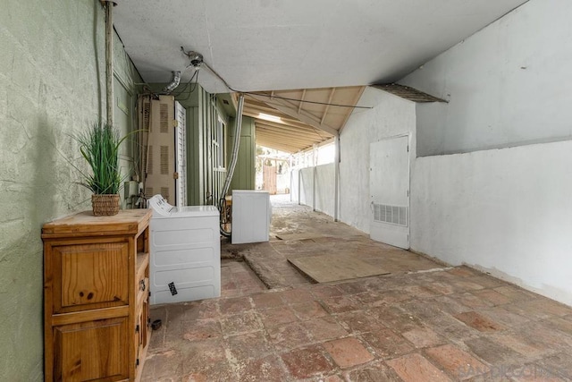 interior space with washer / clothes dryer and lofted ceiling