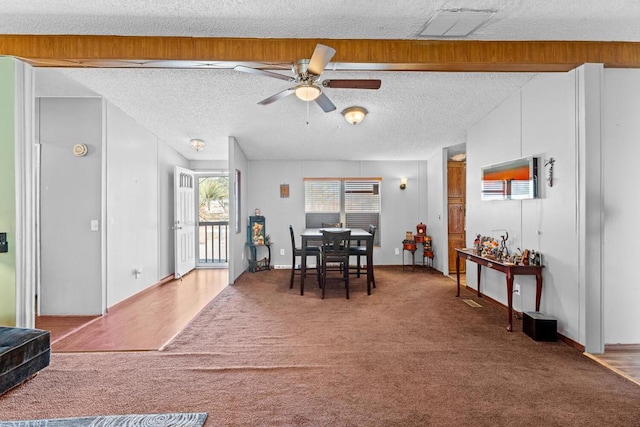 dining room with ceiling fan, carpet, and a textured ceiling