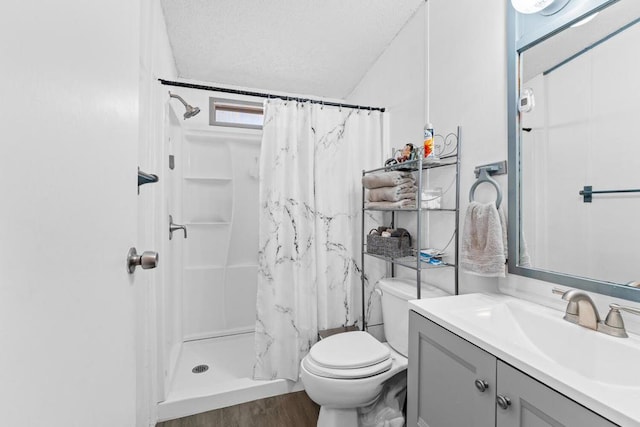 bathroom with walk in shower, toilet, a textured ceiling, vanity, and hardwood / wood-style floors