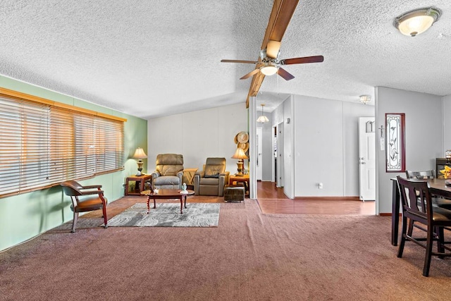 carpeted living room featuring ceiling fan, lofted ceiling, and a textured ceiling