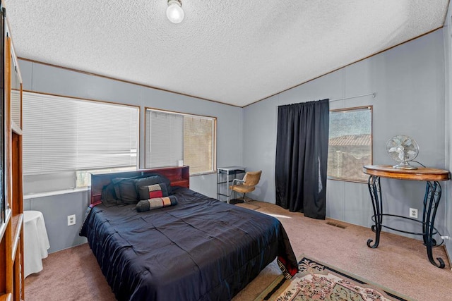 bedroom featuring lofted ceiling, carpet flooring, and a textured ceiling