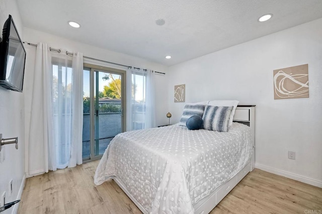 bedroom with access to exterior, light wood-style flooring, recessed lighting, and baseboards