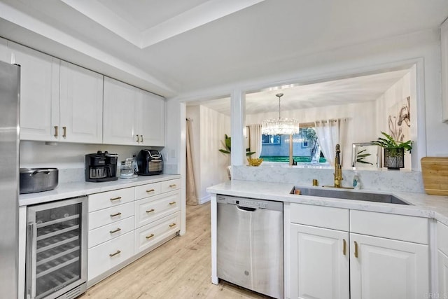 kitchen featuring beverage cooler, a sink, white cabinets, and stainless steel dishwasher