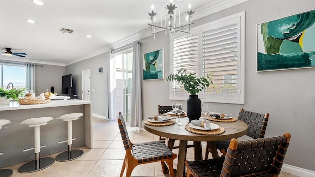 dining room with crown molding, ceiling fan with notable chandelier, and light tile patterned floors