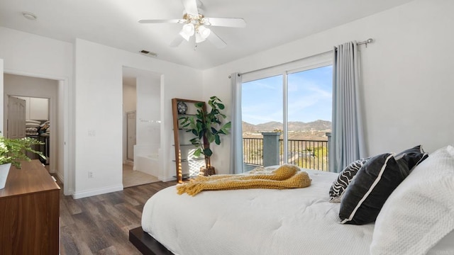 bedroom featuring a mountain view, dark wood-type flooring, access to outside, and ceiling fan