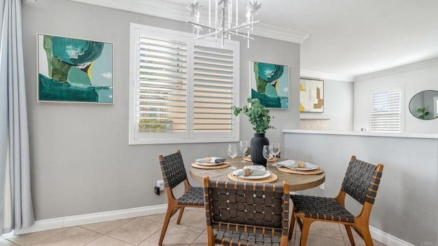 tiled dining area with an inviting chandelier and crown molding