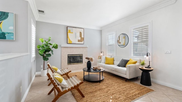 living room featuring a tile fireplace, crown molding, and light tile patterned flooring