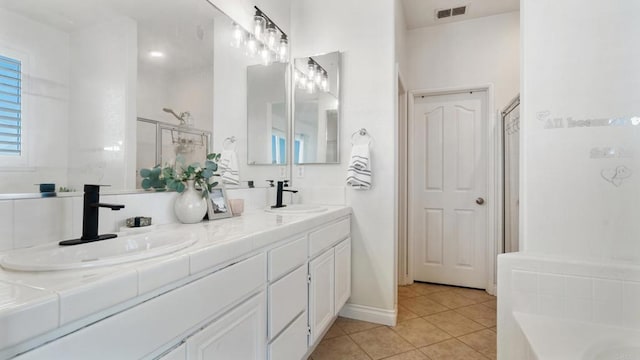 bathroom featuring vanity, tile patterned floors, and a shower with shower door