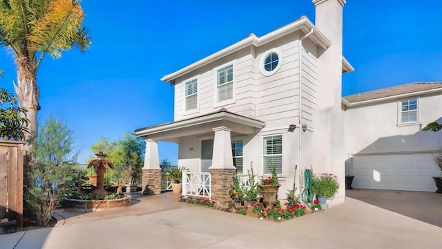 view of front of property featuring a porch and a garage