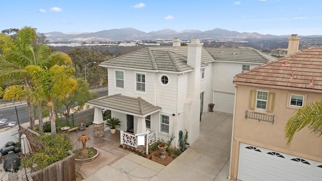 back of property featuring a garage and a mountain view