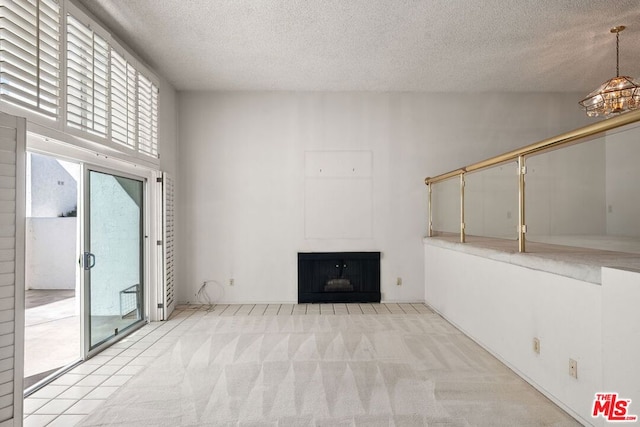 unfurnished living room with light colored carpet and a textured ceiling