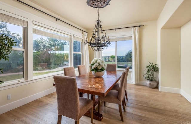 dining space featuring a chandelier, light hardwood / wood-style floors, and a wealth of natural light