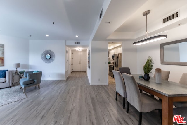 dining space with light hardwood / wood-style floors