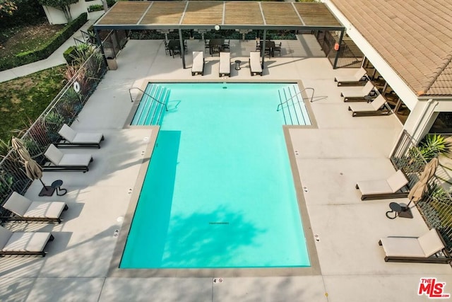 view of swimming pool with a patio