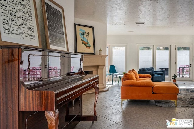 interior space with tile patterned flooring and a textured ceiling