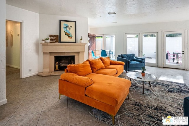 tiled living room with a textured ceiling