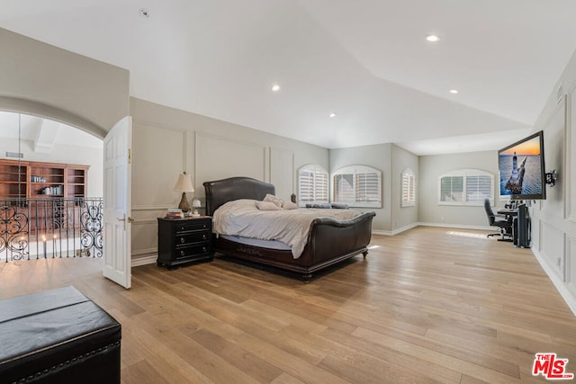 bedroom featuring vaulted ceiling and light wood-type flooring