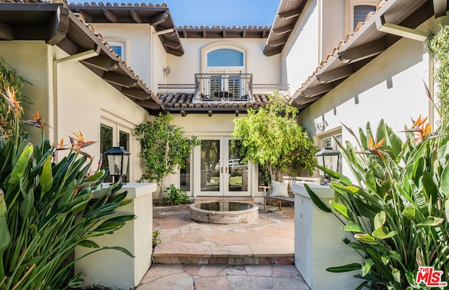 view of patio / terrace featuring french doors and a balcony