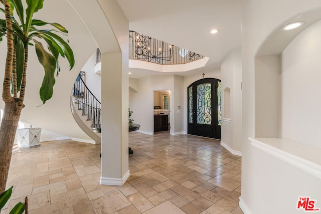 foyer entrance featuring a towering ceiling