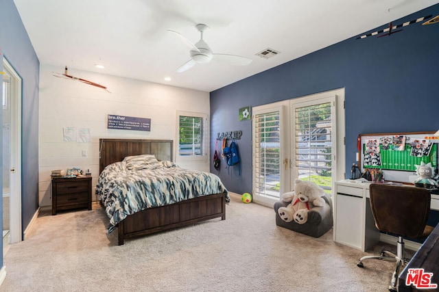 carpeted bedroom featuring access to exterior and ceiling fan