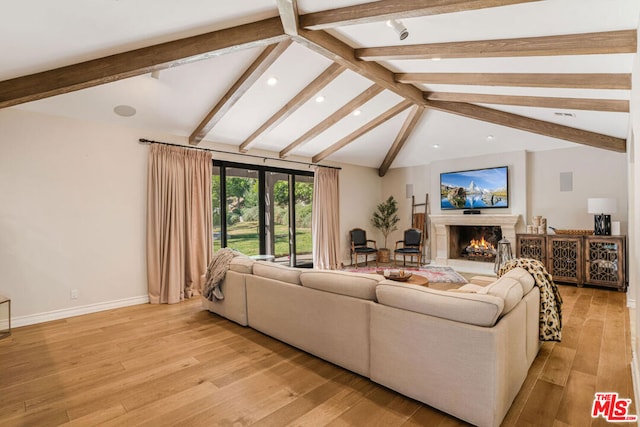 living room with light hardwood / wood-style flooring and lofted ceiling with beams