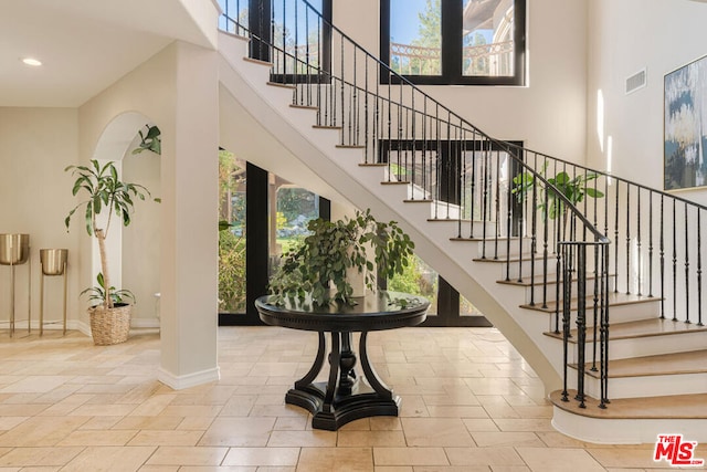 interior space with a high ceiling and a wealth of natural light