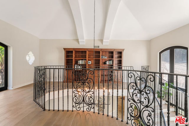 interior space with beamed ceiling and hardwood / wood-style flooring