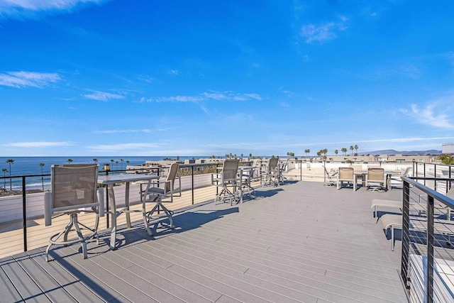 wooden terrace featuring a water view