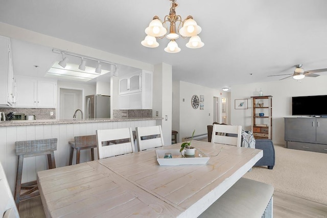 910 N Pacific St Unit 41, Oceanside, CA 92054 - dining room featuring a chandelier, a ceiling fan, and light wood-style floors