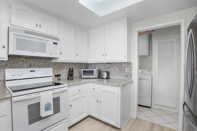 910 N Pacific St Unit 41, Oceanside, CA 92054 - kitchen with white appliances, washer / dryer, white cabinets, and light stone counters