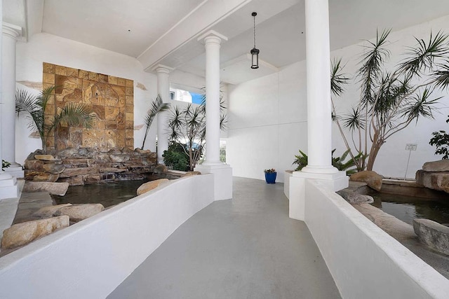910 N Pacific St Unit 41, Oceanside, CA 92054 - corridor with decorative columns and concrete flooring