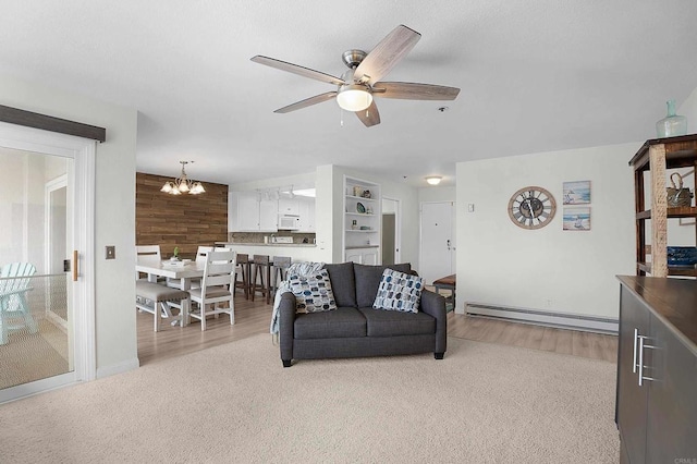 910 N Pacific St Unit 41, Oceanside, CA 92054 - living area featuring baseboard heating, ceiling fan, a chandelier, carpet floors, and baseboards